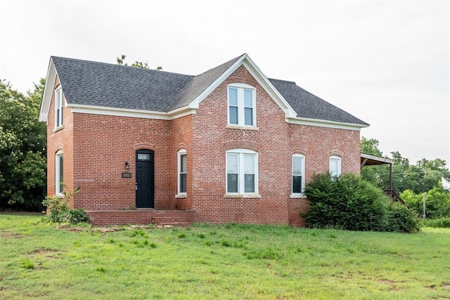 1901 E University Ave, Guthrie, OK 73044 - view of front facade with a shingled roof, brick siding, and a front lawn