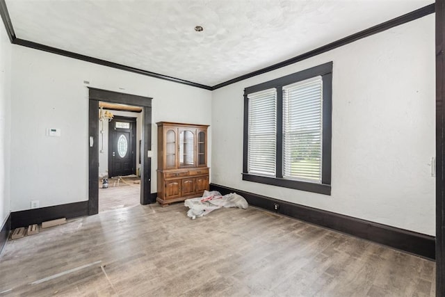 1901 E University Ave, Guthrie, OK 73044 - spare room featuring crown molding and light wood finished floors
