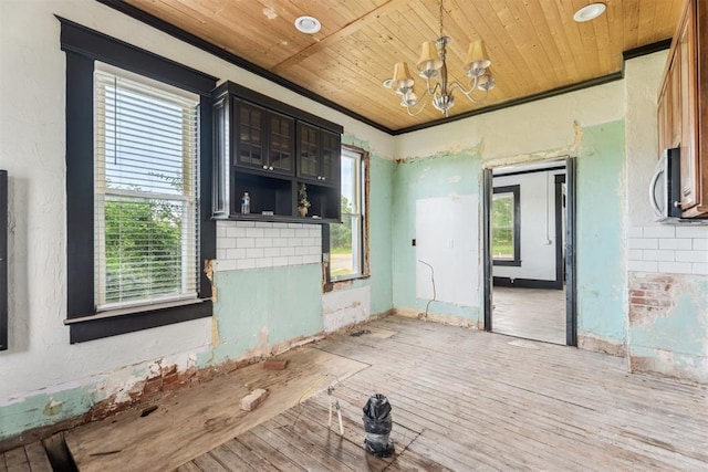 1901 E University Ave, Guthrie, OK 73044 - unfurnished room with wood ceiling, a chandelier, and wood finished floors