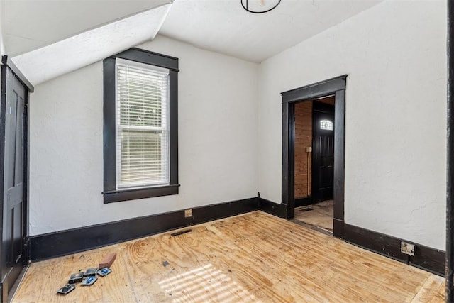 1901 E University Ave, Guthrie, OK 73044 - spare room with vaulted ceiling and wood finished floors