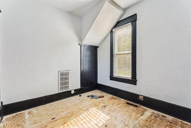 1901 E University Ave, Guthrie, OK 73044 - spare room featuring vaulted ceiling