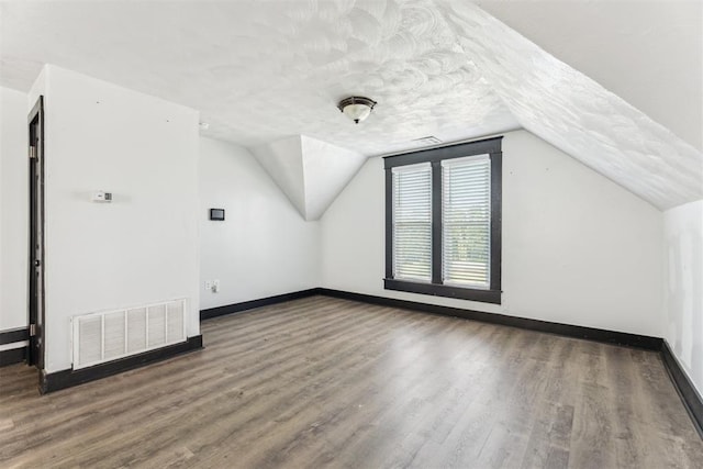 1901 E University Ave, Guthrie, OK 73044 - additional living space with wood finished floors and vaulted ceiling