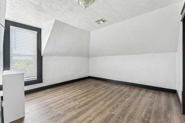 1901 E University Ave, Guthrie, OK 73044 - additional living space featuring wood finished floors and lofted ceiling