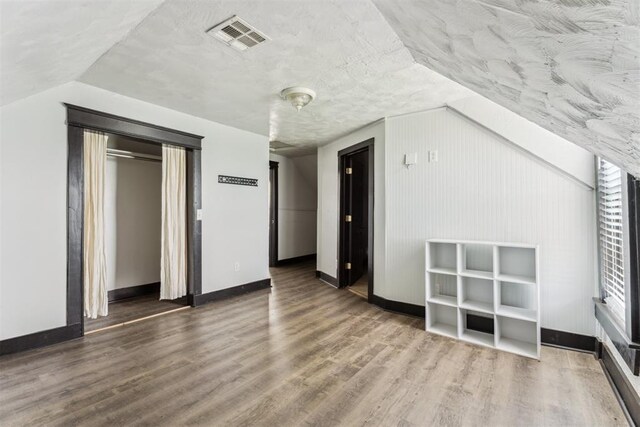 1901 E University Ave, Guthrie, OK 73044 - bonus room featuring lofted ceiling and wood finished floors