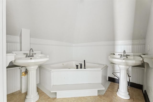 1901 E University Ave, Guthrie, OK 73044 - bathroom with a tub with jets and a wainscoted wall