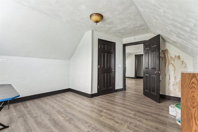 1901 E University Ave, Guthrie, OK 73044 - additional living space featuring lofted ceiling and wood finished floors