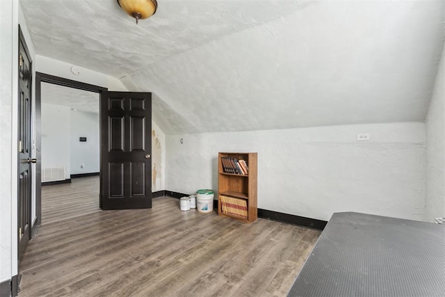 1901 E University Ave, Guthrie, OK 73044 - additional living space featuring vaulted ceiling and wood finished floors