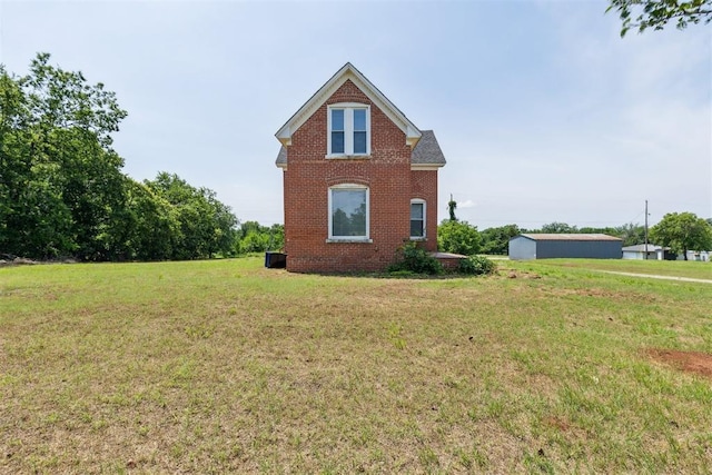 1901 E University Ave, Guthrie, OK 73044 - view of property exterior with brick siding and a lawn