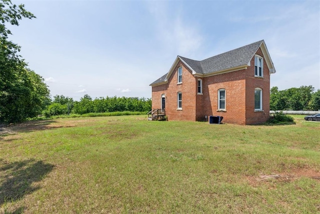 1901 E University Ave, Guthrie, OK 73044 - view of home's exterior with brick siding and a yard