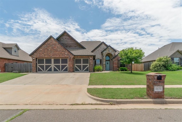view of front of home with a garage, brick siding, and driveway