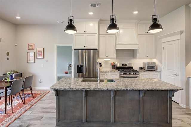3413 NW 159th St, Edmond, OK 73013 - kitchen with stainless steel appliances, custom exhaust hood, white cabinetry, a center island with sink, and a breakfast bar