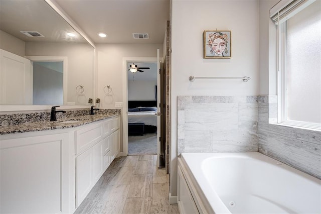 3413 NW 159th St, Edmond, OK 73013 - bathroom with vanity, a whirlpool tub, ensuite bathroom, ceiling fan, and recessed lighting