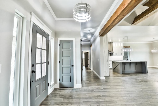 12016 SW 50th St, Mustang, OK 73064 - foyer with ornamental molding, plenty of natural light, light wood-type flooring, and a chandelier