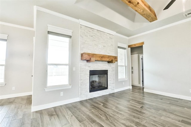 12016 SW 50th St, Mustang, OK 73064 - unfurnished living room featuring wood finished floors, a stone fireplace, ornamental molding, a ceiling fan, and beam ceiling