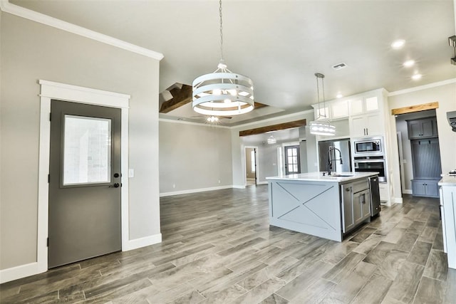 12016 SW 50th St, Mustang, OK 73064 - kitchen featuring appliances with stainless steel finishes, light countertops, a chandelier, crown molding, and decorative light fixtures