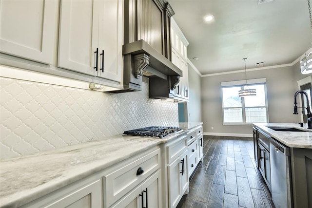 12016 SW 50th St, Mustang, OK 73064 - kitchen with appliances with stainless steel finishes, tasteful backsplash, light stone countertops, crown molding, and hanging light fixtures