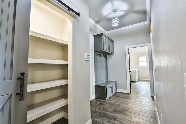 12016 SW 50th St, Mustang, OK 73064 - mudroom featuring crown molding, a barn door, and dark wood-style flooring