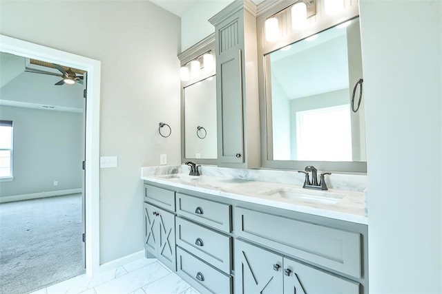 12016 SW 50th St, Mustang, OK 73064 - bathroom with double vanity, a ceiling fan, and marble finish flooring