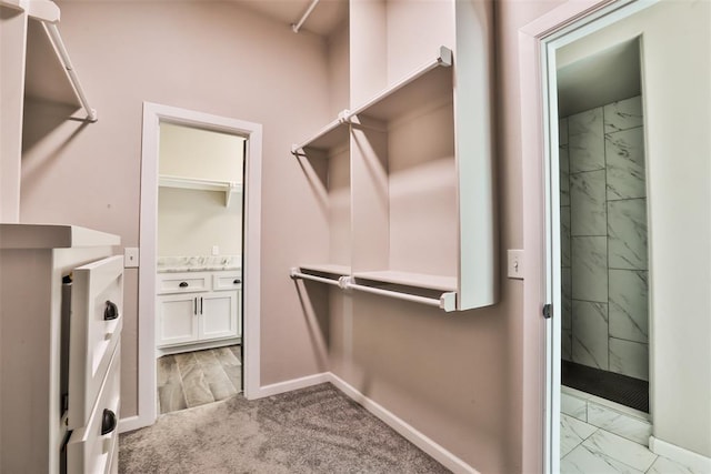 12016 SW 50th St, Mustang, OK 73064 - walk in closet featuring light marble finish flooring