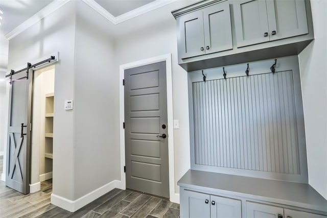 12016 SW 50th St, Mustang, OK 73064 - mudroom featuring dark wood-style floors, crown molding, and a barn door