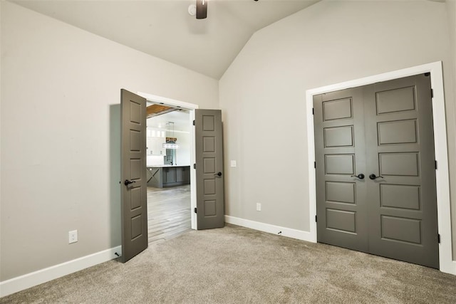 12016 SW 50th St, Mustang, OK 73064 - unfurnished bedroom with vaulted ceiling, carpet floors, a closet, and a ceiling fan
