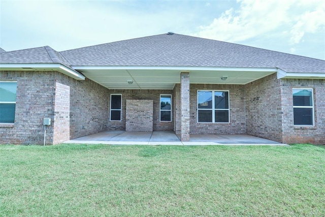 12016 SW 50th St, Mustang, OK 73064 - rear view of property featuring roof with shingles, a patio, and a lawn