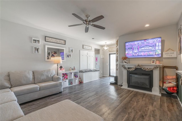 11513 Ruger Rd, Yukon, OK 73099 - living area featuring wood finished floors, a ceiling fan, recessed lighting, and a glass covered fireplace