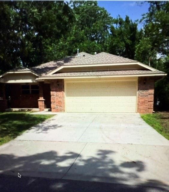 1523 Morland St, Norman, OK 73071 - single story home with a garage, brick siding, and concrete driveway