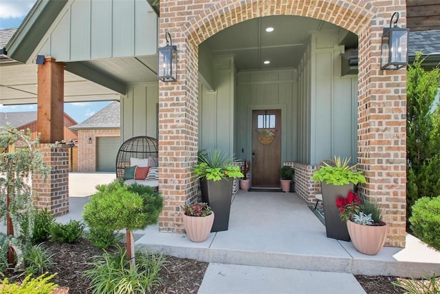 3154 Red Ridge Dr, Blanchard, OK 73010 - doorway to property featuring brick siding, board and batten siding, and covered porch