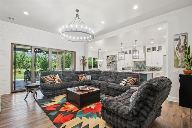 3154 Red Ridge Dr, Blanchard, OK 73010 - living room featuring a chandelier, wood finished floors, and recessed lighting