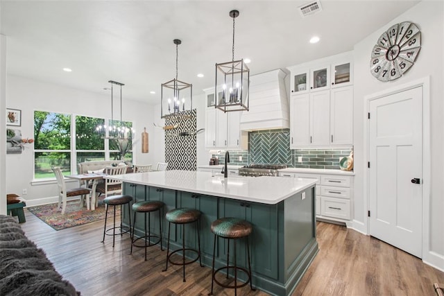 3154 Red Ridge Dr, Blanchard, OK 73010 - kitchen with a chandelier, a kitchen island with sink, tasteful backsplash, white cabinets, and recessed lighting