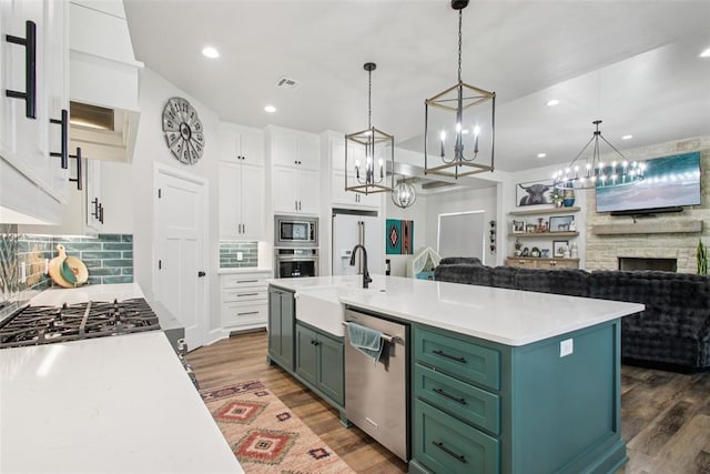 3154 Red Ridge Dr, Blanchard, OK 73010 - kitchen with appliances with stainless steel finishes, green cabinets, a sink, light countertops, and recessed lighting