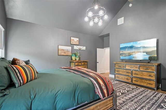 3154 Red Ridge Dr, Blanchard, OK 73010 - bedroom with high vaulted ceiling, a chandelier, wood finished floors, and baseboards