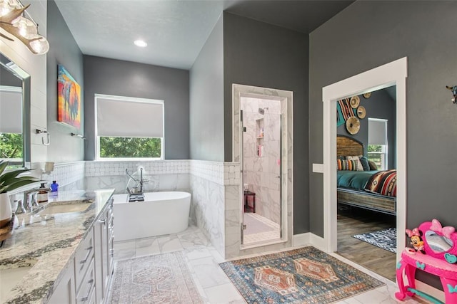3154 Red Ridge Dr, Blanchard, OK 73010 - full bathroom featuring a stall shower, a freestanding bath, double vanity, ensuite bath, and tile walls