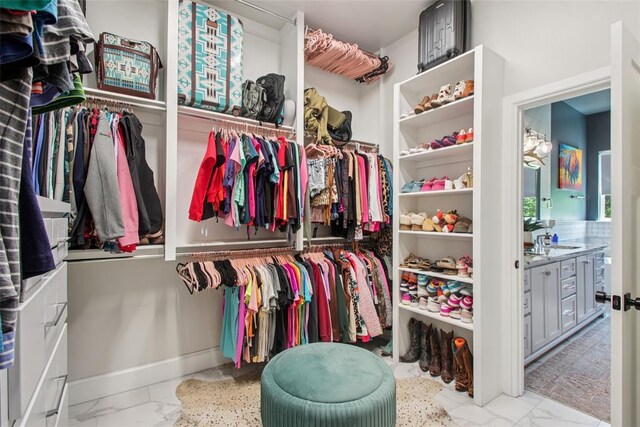 3154 Red Ridge Dr, Blanchard, OK 73010 - walk in closet with marble look tile flooring and a sink