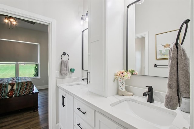 3154 Red Ridge Dr, Blanchard, OK 73010 - ensuite bathroom with double vanity, wood finished floors, and a ceiling fan