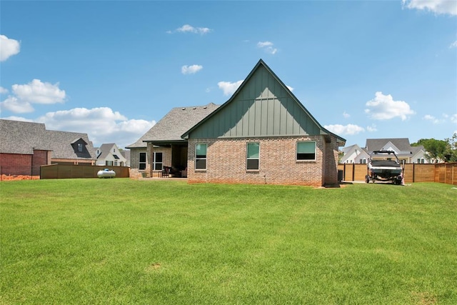 3154 Red Ridge Dr, Blanchard, OK 73010 - rear view of house featuring board and batten siding and brick siding
