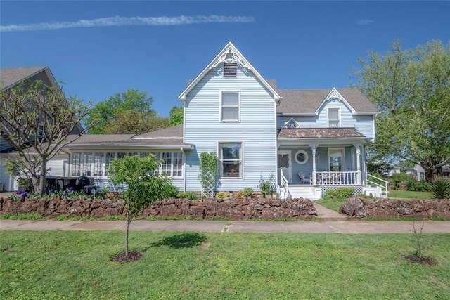 201 W 8th St, Chandler, OK 74834 - victorian house featuring covered porch and a front lawn