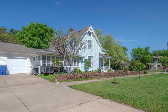201 W 8th St, Chandler, OK 74834 - view of front of house featuring an attached garage, driveway, and a front yard