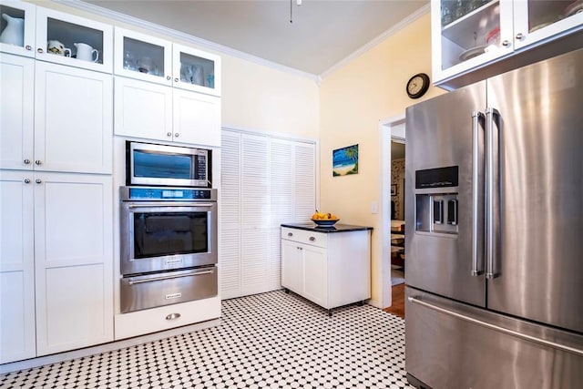 201 W 8th St, Chandler, OK 74834 - kitchen with appliances with stainless steel finishes, a warming drawer, crown molding, white cabinets, and glass insert cabinets