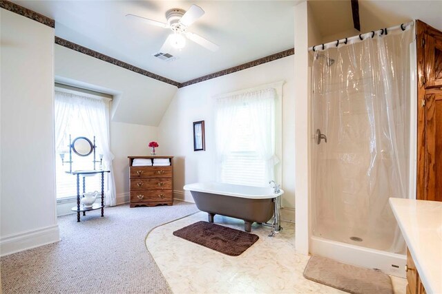 201 W 8th St, Chandler, OK 74834 - bathroom with a soaking tub, ceiling fan, a shower with shower curtain, vaulted ceiling, and baseboards