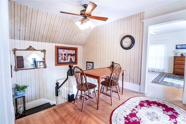 201 W 8th St, Chandler, OK 74834 - dining room featuring wallpapered walls, wood finished floors, a ceiling fan, baseboards, and vaulted ceiling
