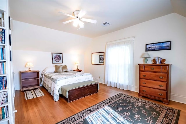201 W 8th St, Chandler, OK 74834 - bedroom featuring wood finished floors, lofted ceiling, baseboards, and ceiling fan