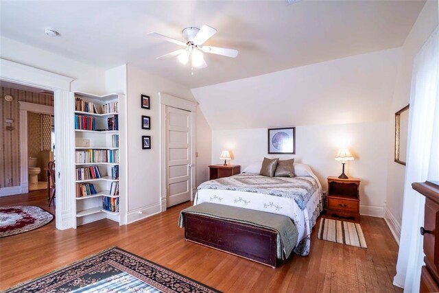 201 W 8th St, Chandler, OK 74834 - bedroom featuring baseboards, wood finished floors, lofted ceiling, and ceiling fan