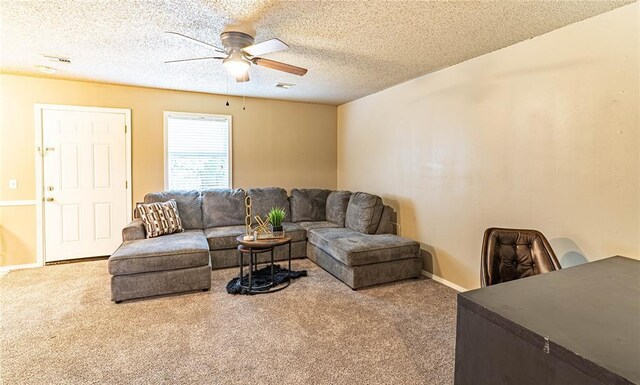 1343 E Moses St, Cushing, OK 74023 - living room with carpet, ceiling fan, baseboards, and a textured ceiling