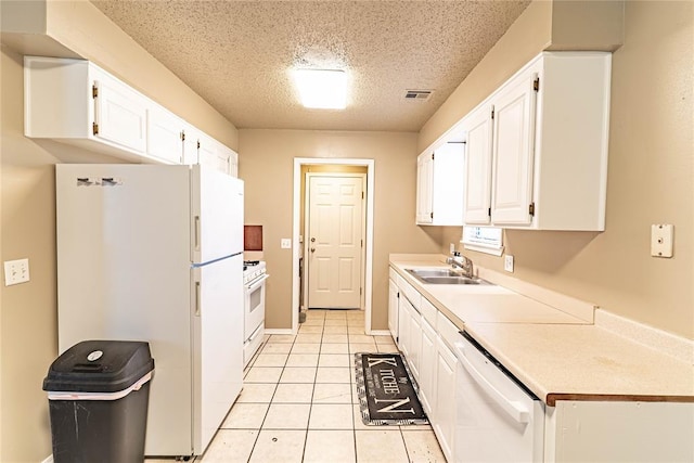 1343 E Moses St, Cushing, OK 74023 - kitchen featuring white appliances, a sink, a textured ceiling, white cabinetry, and light countertops