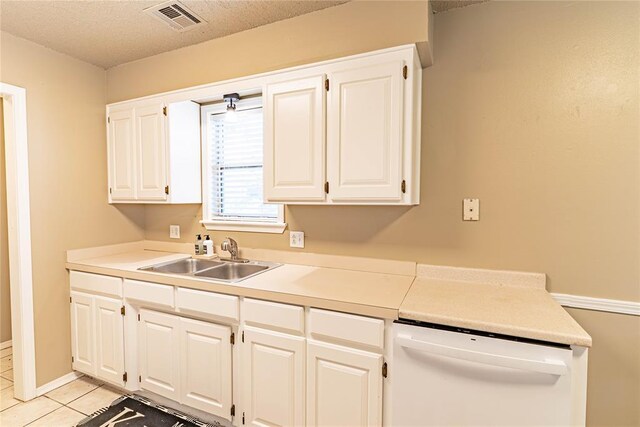 1343 E Moses St, Cushing, OK 74023 - kitchen with a sink, white dishwasher, white cabinets, light tile patterned flooring, and light countertops
