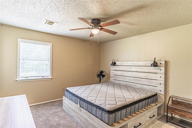 1343 E Moses St, Cushing, OK 74023 - carpeted bedroom featuring ceiling fan, a textured ceiling, and baseboards