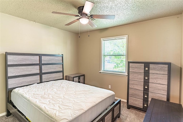 1343 E Moses St, Cushing, OK 74023 - carpeted bedroom with baseboards, a textured ceiling, and ceiling fan