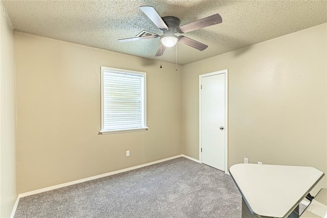 1343 E Moses St, Cushing, OK 74023 - carpeted spare room featuring ceiling fan, a textured ceiling, and baseboards